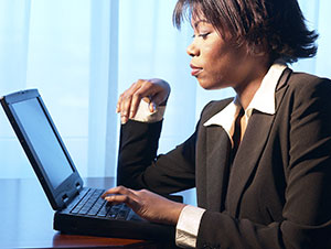 A woman takes a survey on a laptop.