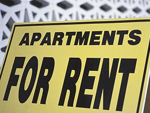 Apartments for rent sign.