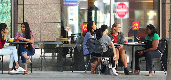 People sitting outside of a cafe.