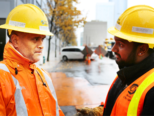 Two City Light employees talking near a work site.