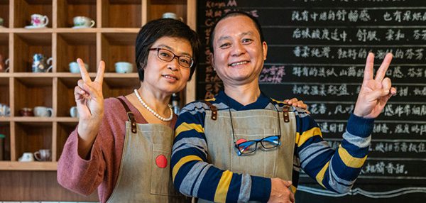 Two business owners posing in their retail store.
