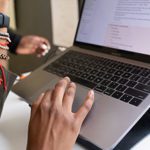 A person using a laptop to access their street use projects online.