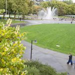 People walking along a path toward the fountain at Seattle Center.